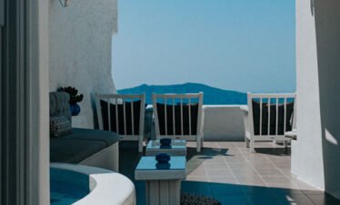 Private outdoor terrace with lounge chairs and sea view.
