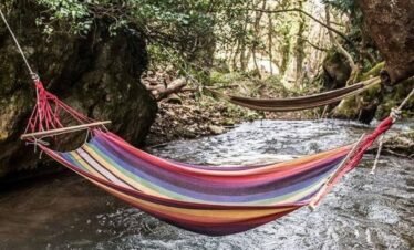 Colorful hammocks over a stream in Pavliani village, Oiti National Park, Greece