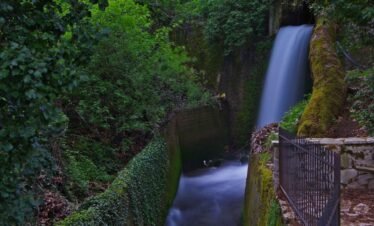 Waterfall flowing through a forest ravine in Agoriani (Eptalofos), Mount Parnassos, Greece