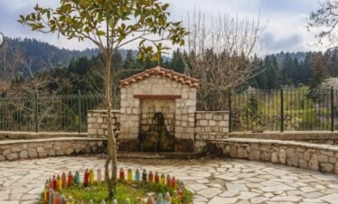Traditional stone fountain in Pavliani village, surrounded by forest, Central Greece