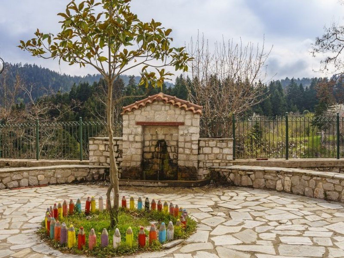 Traditional stone fountain in Pavliani village, surrounded by forest, Central Greece